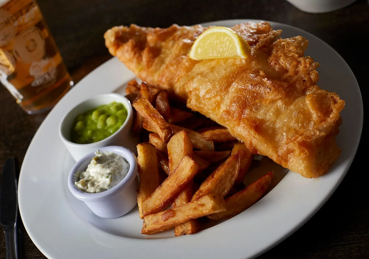 Battered fish and chips with mushy peas and tartare sauce