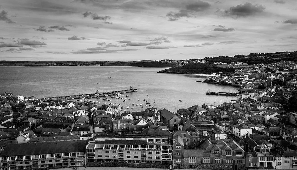 Black and white aerial view over a harbour town