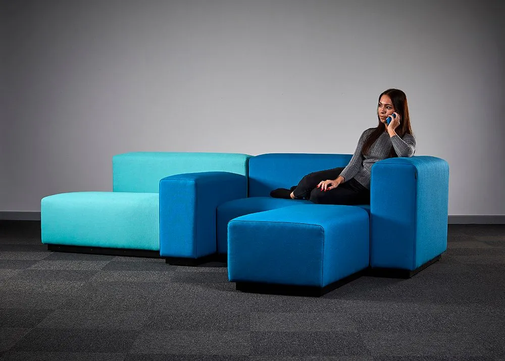 Blue modular office sofa photographed in the studio with a model