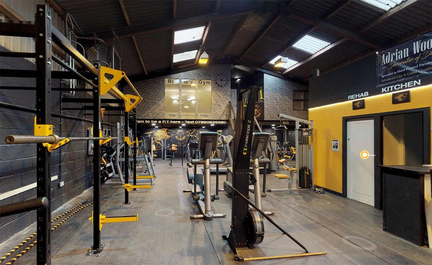 Gym floor with rigs, benches and cardio machines