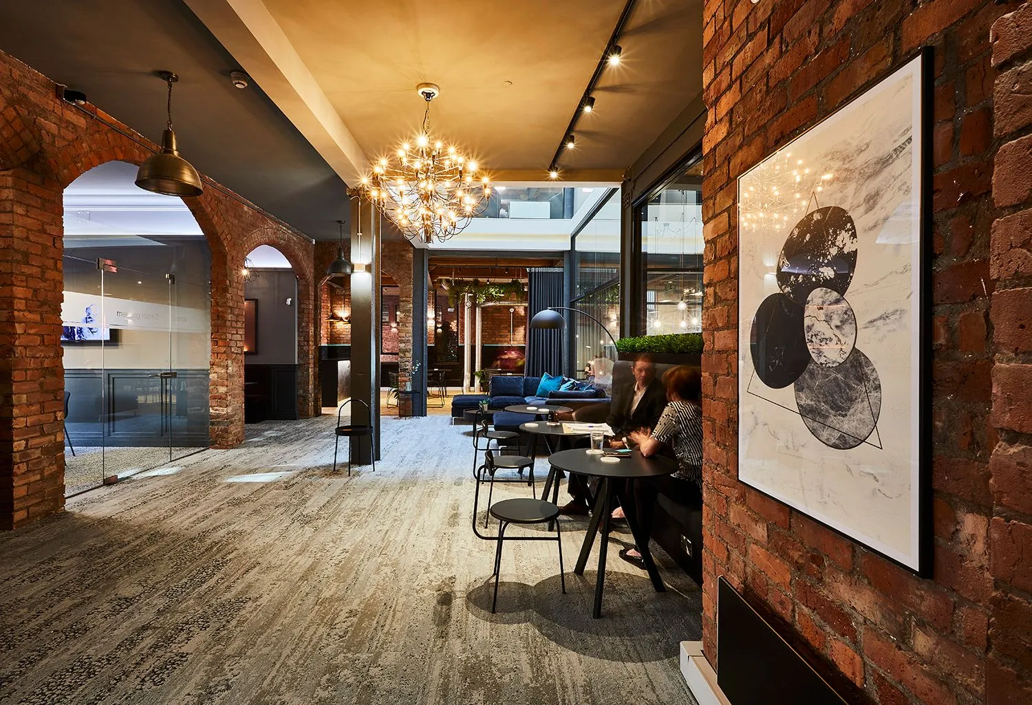 Restaurant with exposed brick arches and a chandelier