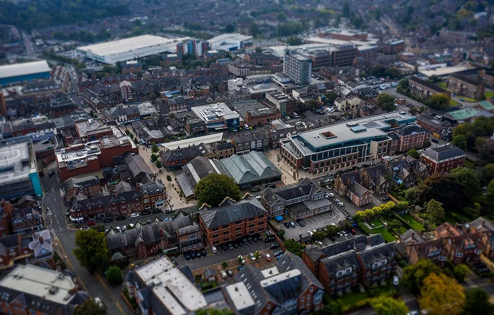 Aerial view over red-brick rooftops and offices