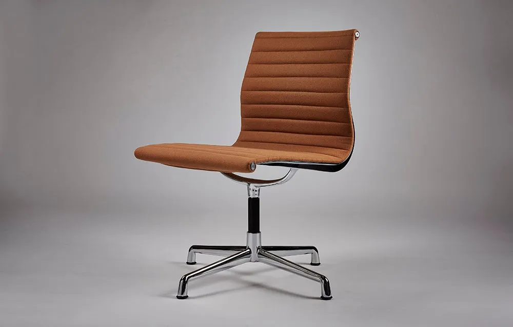 Aluminium-framed office chair with tan ribbed upholstery on a grey seamless backdrop