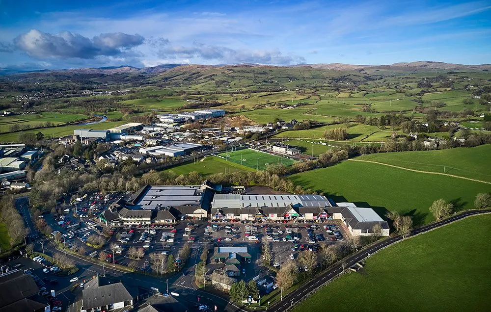 Aerial view of a retail park with moorland behind